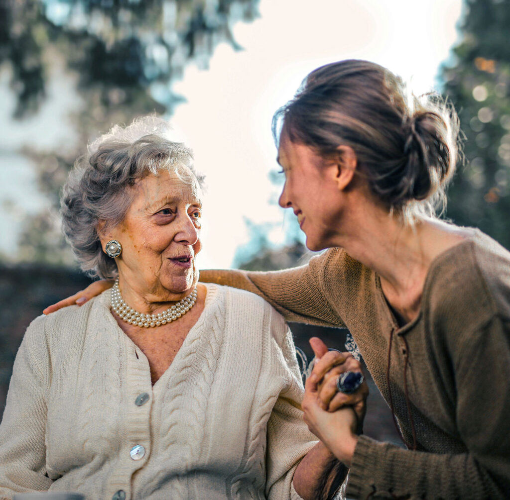 Grandmother embraced by granddaughter, symbolizing patient-centred cardiac care with Cardio-HART for commissioners