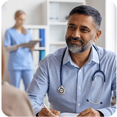 Primary care doctor with Cardio-HART AI diagnostic for early detection of heart disease General practitioner using Cardio-HART AI heart diagnostic in primary care